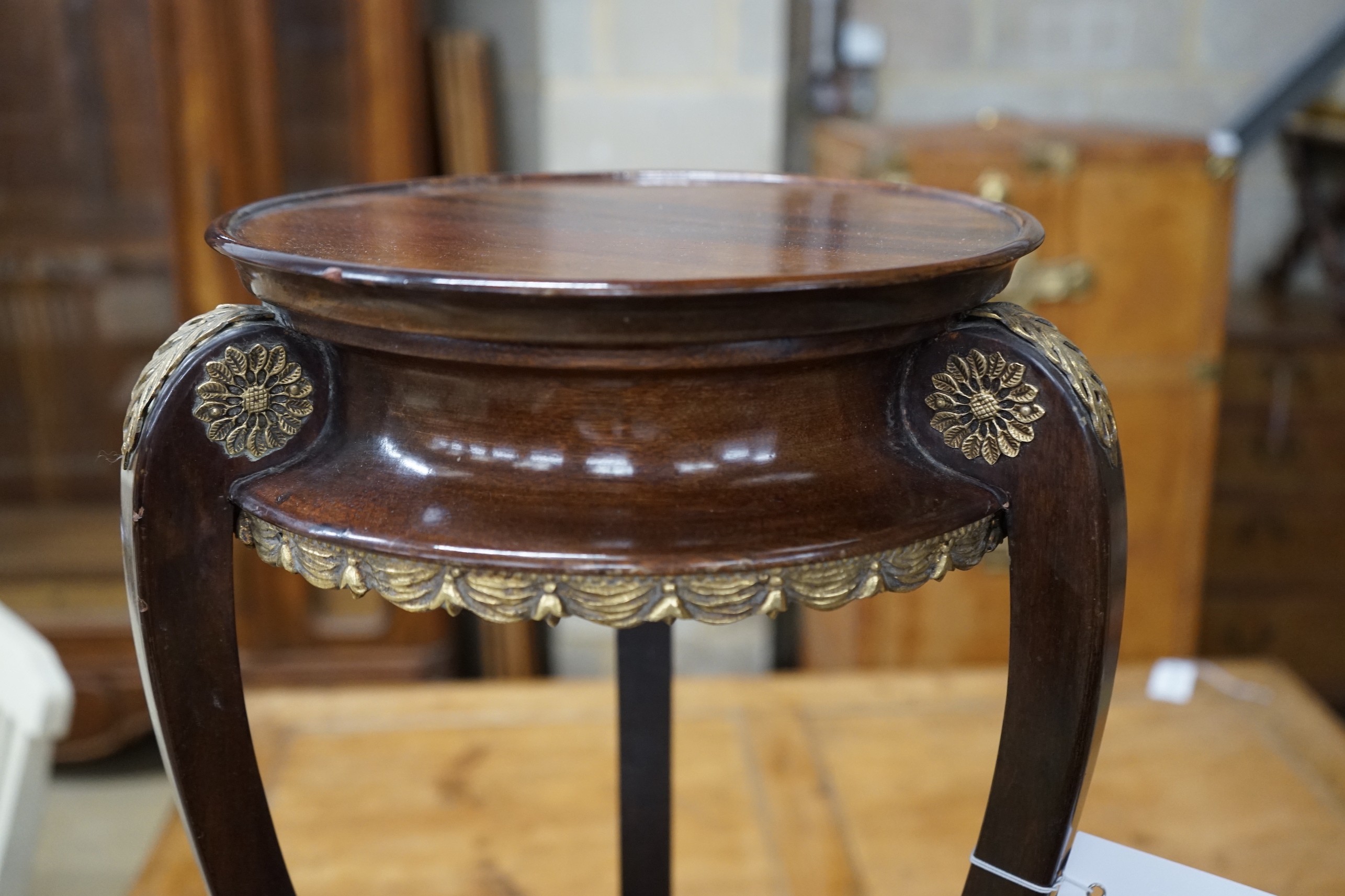 A French gilt metal mounted mahogany Empire style vase stand, height 67cm and an Arts and Crafts brass bound staved mahogany circular jardiniere, diameter 35cm, height 78cm